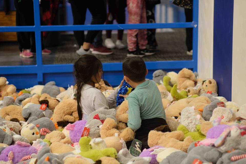 Two kids take a deep dive to choose a stuffed animal Saturday at the 10th annual Northside Toy Drive held at the Palo Duro High School Gym in Amarillo.