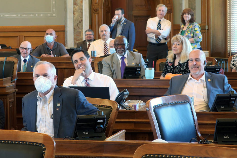 FILE - In this Thursday, June 4, 2020, file photo, Republican members of the Kansas House, some wearing protective masks and some not, listen to humorous announcements as they prepare to take a lunch break, at the Statehouse in Topeka, Kan. Republican governors and state lawmakers in many states have followed President Donald Trump’s lead in downplaying the seriousness of the coronavirus virus, refusing to wear masks and fighting against coronavirus restrictions on businesses and social gatherings. Revelations that the president and first lady are now among those who have tested positive for the disease did little to change their thinking. (AP Photo/John Hanna, File)