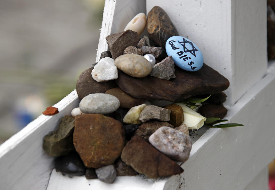 These are stones placed Thursday, Nov. 1, 2018, at a makeshift memorial outside the Tree of Life Synagogue to the 11 people killed Oct 27, 2018 while worshipping in the Squirrel Hill neighborhood of Pittsburgh. (AP Photo/Gene J. Puskar)