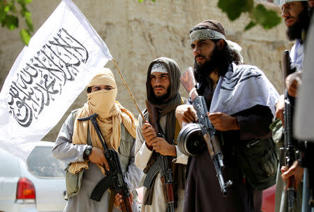 FILE PHOTO:Taliban walk as they celebrate ceasefire in Ghanikhel district of Nangarhar province, Afghanistan June 16, 2018. picture taken on June 16, 2018.REUTERS/Parwiz