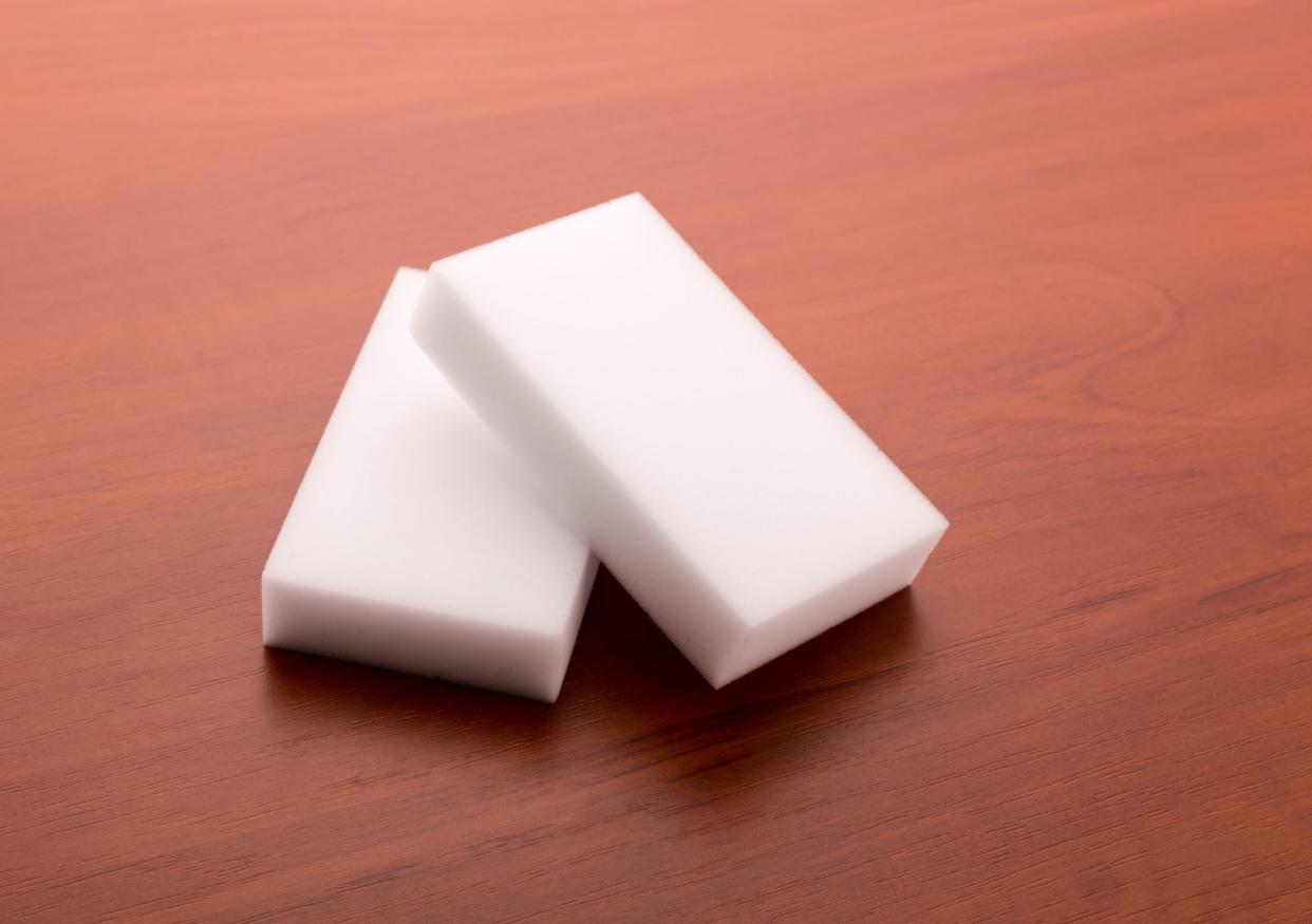 Two melamine sponges on wooden table