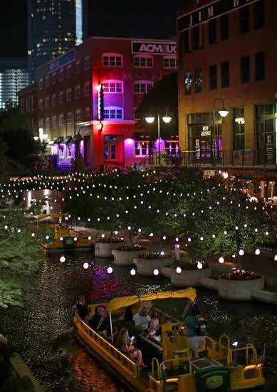 Visitors take a cruise down the Bricktown Canal on a recent summer night.