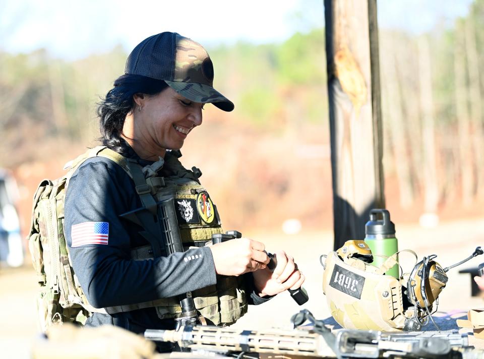 Former Congresswoman Tulsi Gabbard loads ammo before taking part in the 2021 Tactical Challenge at the U.S. Army John F. Kennedy Special Warfare Center and School's Miller Training Complex on Dec. 16, 2021. Twelve celebrities teamed up with Green Berets to take part in the annual event.