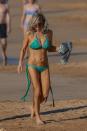 <p>Wearing a green printed string bikini.<br><i>[Photo: FameFlynet]</i> </p>