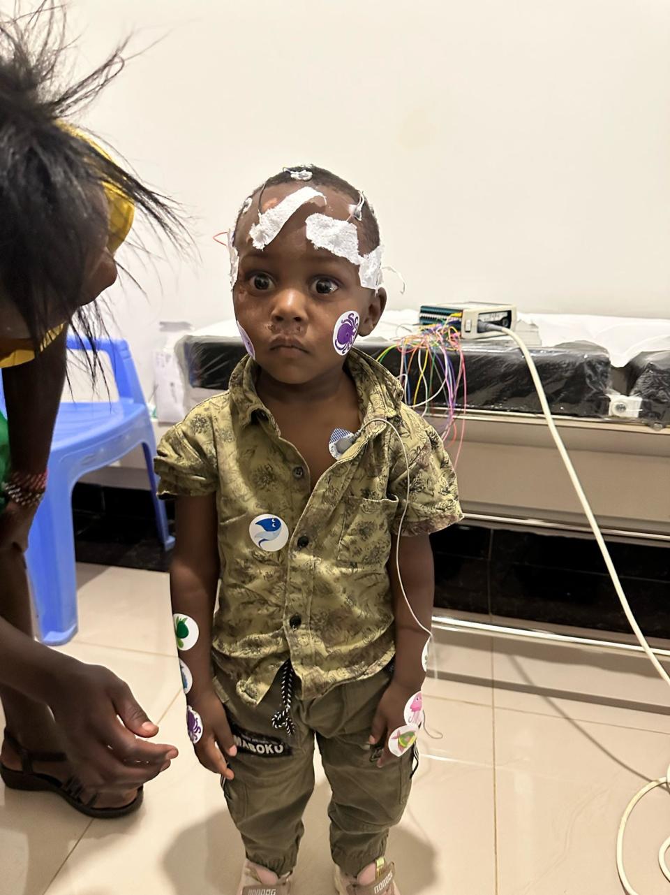 A patient at the Kenyan clinic gets fitted with electrodes to track his seizures and brain activity.