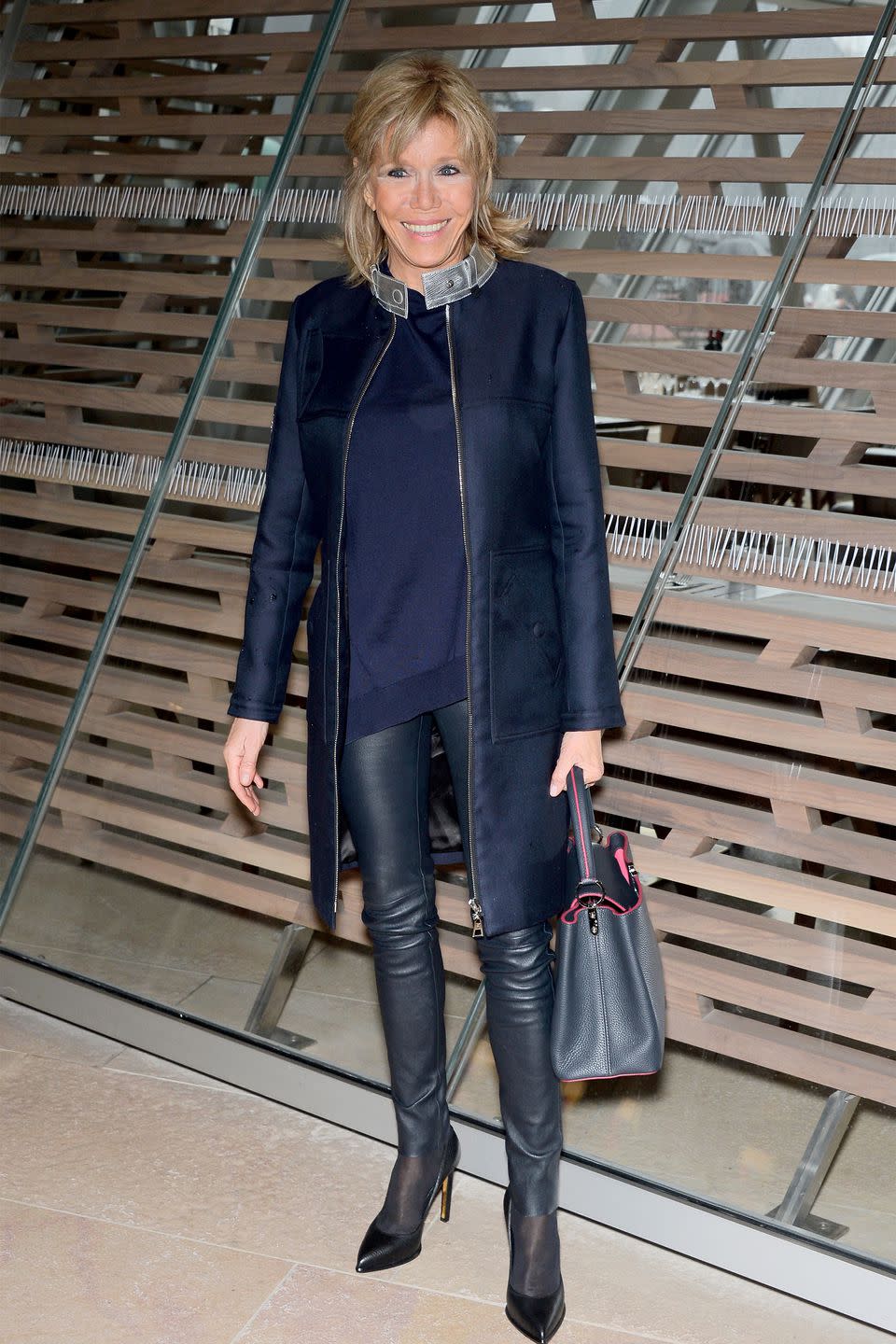 <p>In a navy jacket and sweater with leather pants and pointed-toe heels while attending the Louis Vuitton fashion show in Paris, France.</p>