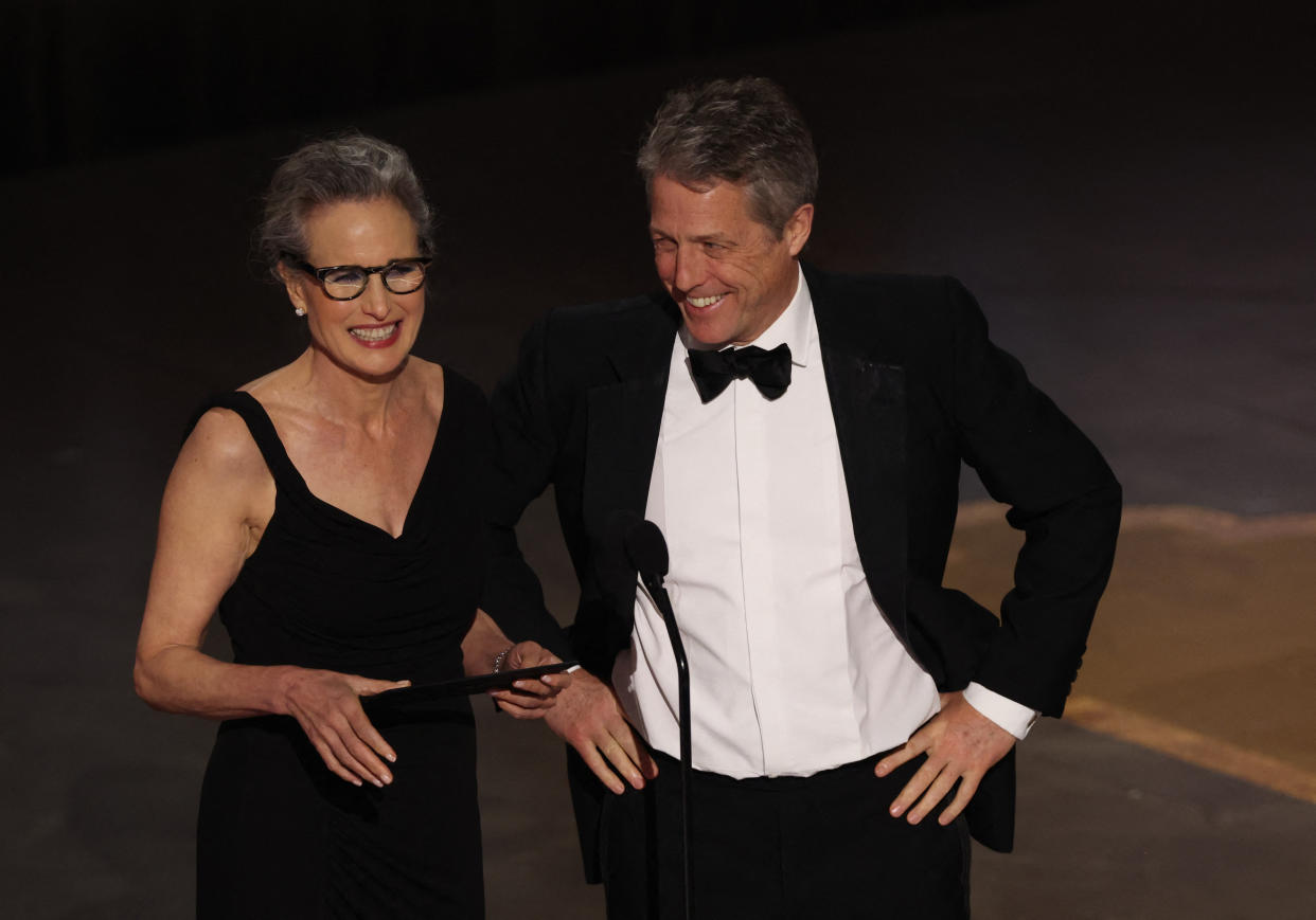 Hugh Grant and Andie MacDowell present an award during the Oscars show at the 95th Academy Awards in Hollywood, Los Angeles, California, U.S., March 12, 2023. REUTERS/Carlos Barria