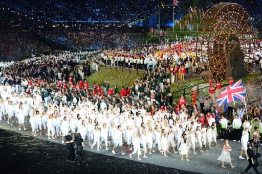 Britain's flagbearer Chris Hoy (R) leads the delegation as they parade during the opening ceremony of the London 2012 Olympic Games, on July 27