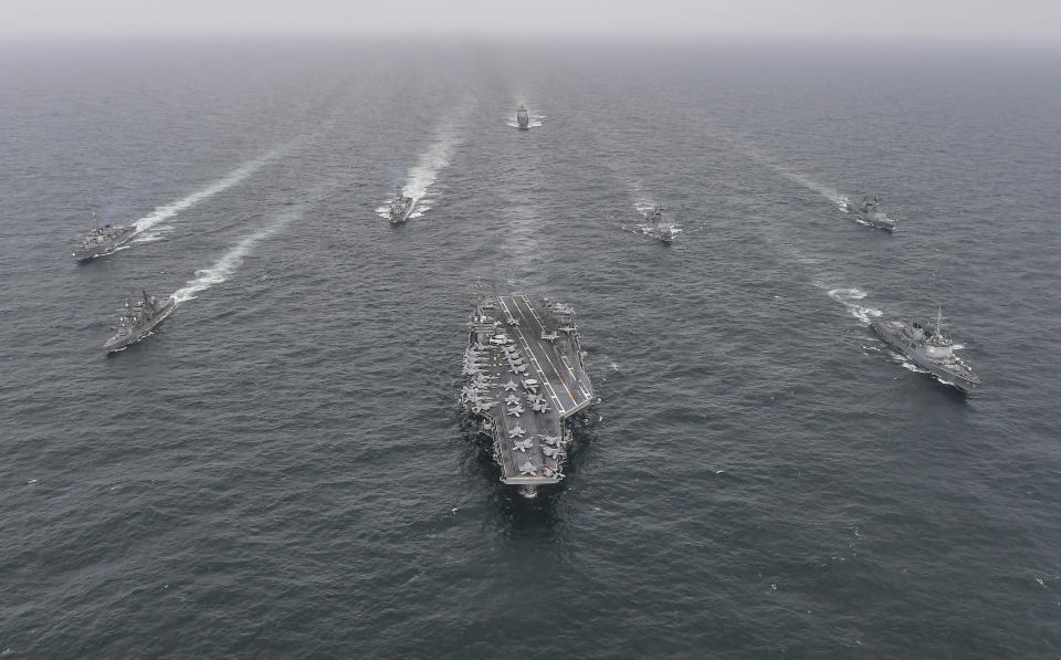 FILE - In this photo provided by the South Korea Defense Ministry, South Korean Navy's destroyer Yulgok Yi I, front row right, U.S. Navy's aircraft carrier USS Nimitz, center, Japan Maritime Self-Defense Force's Umigiri, front row left, sail in formation during a joint naval exercise in international waters off South Korea's southern island of Jeju on April 4, 2023. North Korea’s recent escalation of threats and endless tests of weapons aimed toward South Korea haven't done much to upset the calm in Seoul. Residents in the South's capital feel they've seen it all before and it's North Korea's way of getting attention in an election year for South Korea and the U.S. (South Korea Defense Ministry via AP, File)