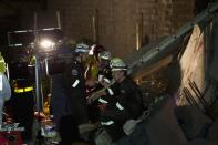 Emergency workers are seen during their search for survivors after a building collapsed in Tongaat, north of Durban, November 19, 2013. At least one person was killed and dozens were feared trapped under rubble on Tuesday after a soccer pitch-sized section of a shopping mall under construction collapsed near the South African city of Durban, emergency services and police said. REUTERS/Rogan Ward (SOUTH AFRICA - Tags: DISASTER)