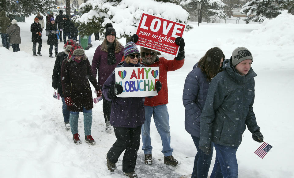 Snow falls as rally goers arrive at Boom Island Park for Democratic Sen. Amy Klobuchar's announcement of her decision in the race for president at a rally Sunday, Feb. 10, 2019, at Boom Island Park in Minneapolis. (AP Photo/Jim Mone)