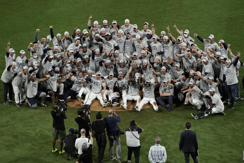 Tampa Bay Rays pose with the American League championship trophy following their victory against the Houston Astros in Game 7 of a baseball American League Championship Series, Saturday, Oct. 17, 2020, in San Diego. The Rays defeated the Astros 4-2 to win the series 4-3 games. (AP Photo/Jae C. Hong)