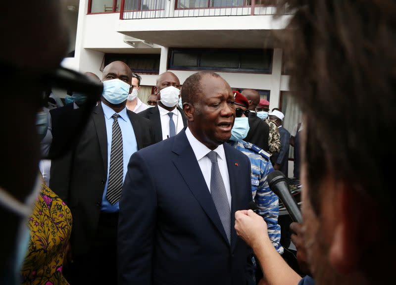 Ivory Coast President and presidential candidate Alassane Ouattara speaks to the media after casting his vote at a polling station during the presidential election in Abidjan