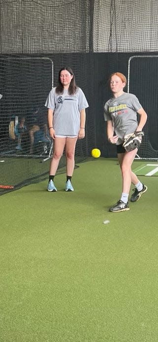 Scarlett Johnson works with a young pitcher in a lesson.