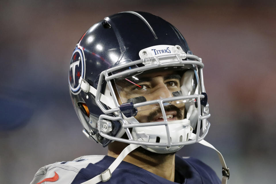 FILE - In this Nov. 24, 2019, file photo, Tennessee Titans quarterback Marcus Mariota looks at the scoreboard in the second half of an NFL football game against the Jacksonville Jaguars in Nashville, Tenn. The Tennessee Titans benched Mariota for Ryan Tannehill in mid-October after a 2-4 start. (AP Photo/James Kenney, File)