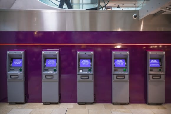 Bank of ATM machines in a conference center lobby.