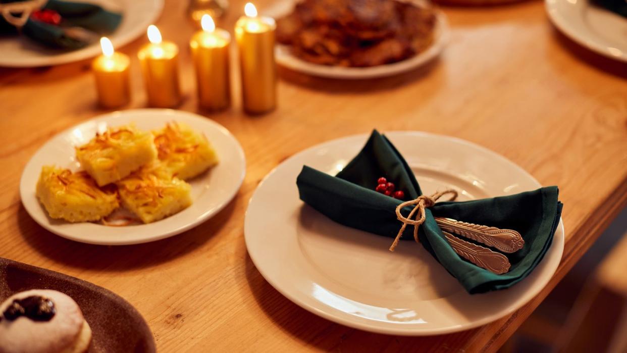 decorated dining table with traditional jewish food for hanukkah