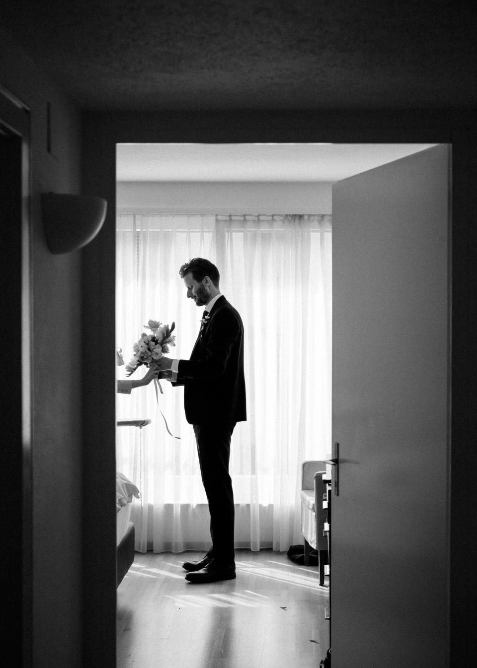 Moments before we left the hotel, Philip held my bouquet as I wrapped it with yards of vintage silk ribbon.