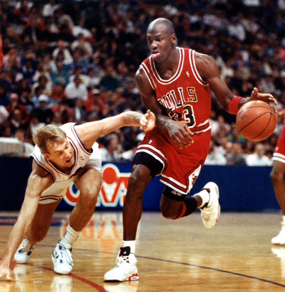Cleveland Cavaliers guard Craig Ehlo, left, can't quite keep up with the Chicago Bulls' Michael Jordan as he drives to the basket at the Richfield Coliseum, Feb. 18, 1991, in Richfield, Ohio.