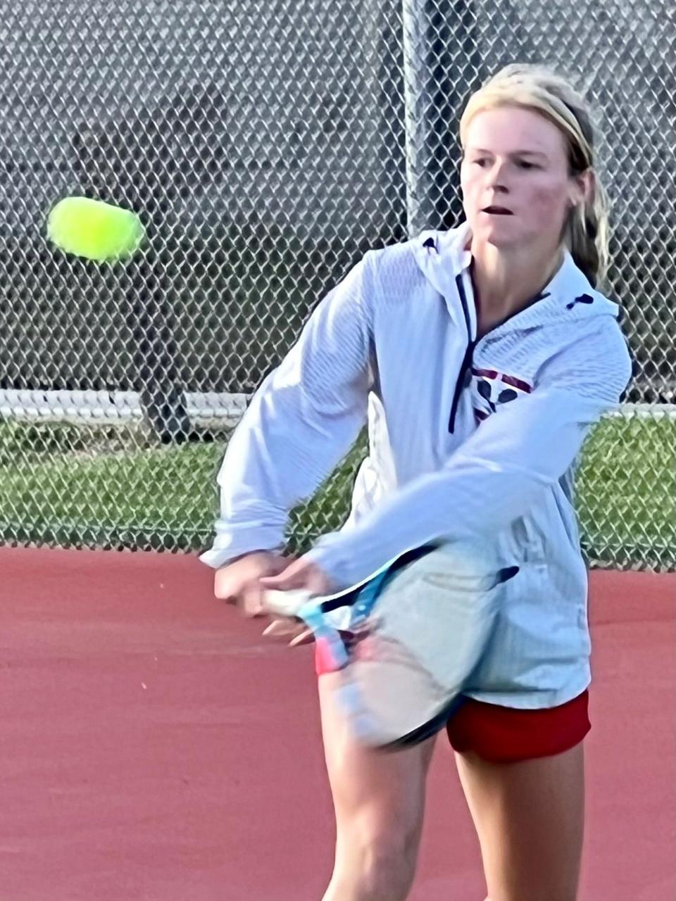 Marion Harding's Taryn Simmers uses a backhand to return a shot during a girls tennis match at Pleasant this season. Simmers was named Fahey Bank Athlete of the Month for August among Marion County girls.