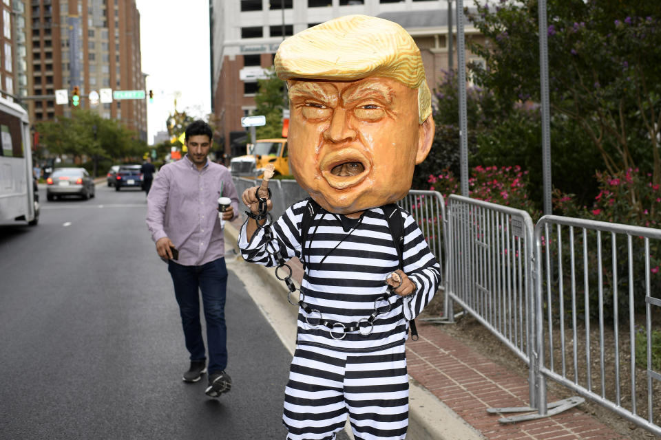 A person dressed as President Donald Trump walks near the U.S. House Republican Member Retreat, Thursday, Sept. 12, 2019, in Baltimore. (AP Photo/Nick Wass)