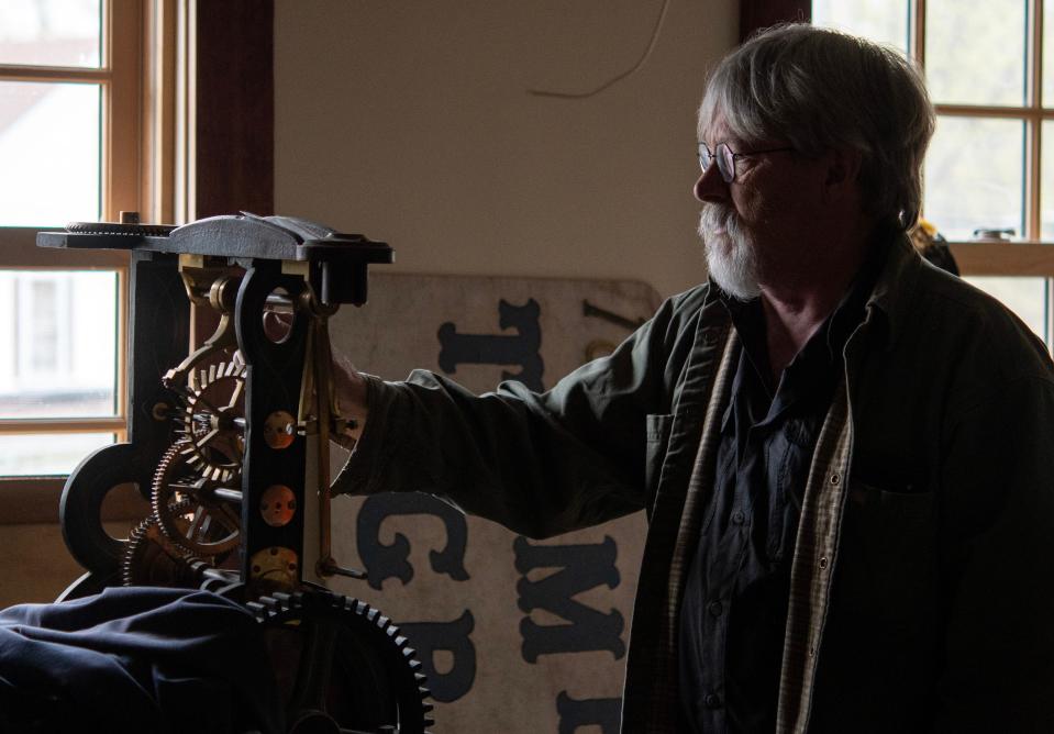 Brian Tanguay, president of the Narragansett Historical Society, describes the workings of an 1872 tower clock made by E. Howard clockmakers of Boston which came from a Baptist Church in Baldwinville.