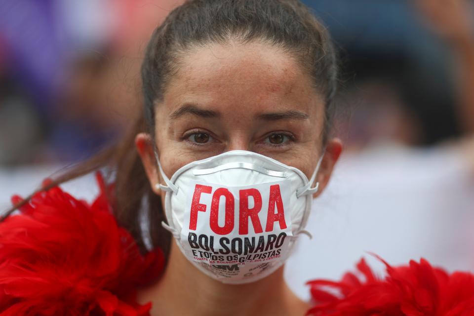 ‘Fora Bolsonaro’ — meaning ‘Bolsonaro out!’ A woman protests against Brazil’s President Jair Bolsonaro’s handling of Covid-19  (REUTERS)