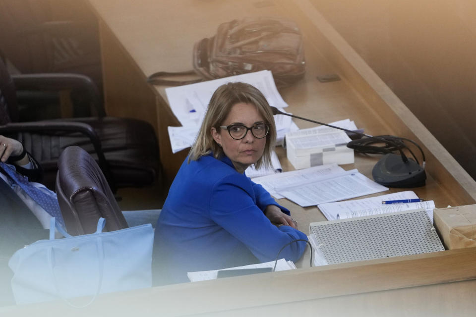 Prosecuting Magistrate Carmen Ruggiero sits in the in bunker hall of Lecce, Italy before the start of an audience Wednesday, May 22, 2024. In the past few months, Carmen Ruggiero, the prosecutor leading the team against a clan in a case known as "Operation Wol." was threatened by a jailed mafioso. (AP Photo/Alessandra Tarantino)