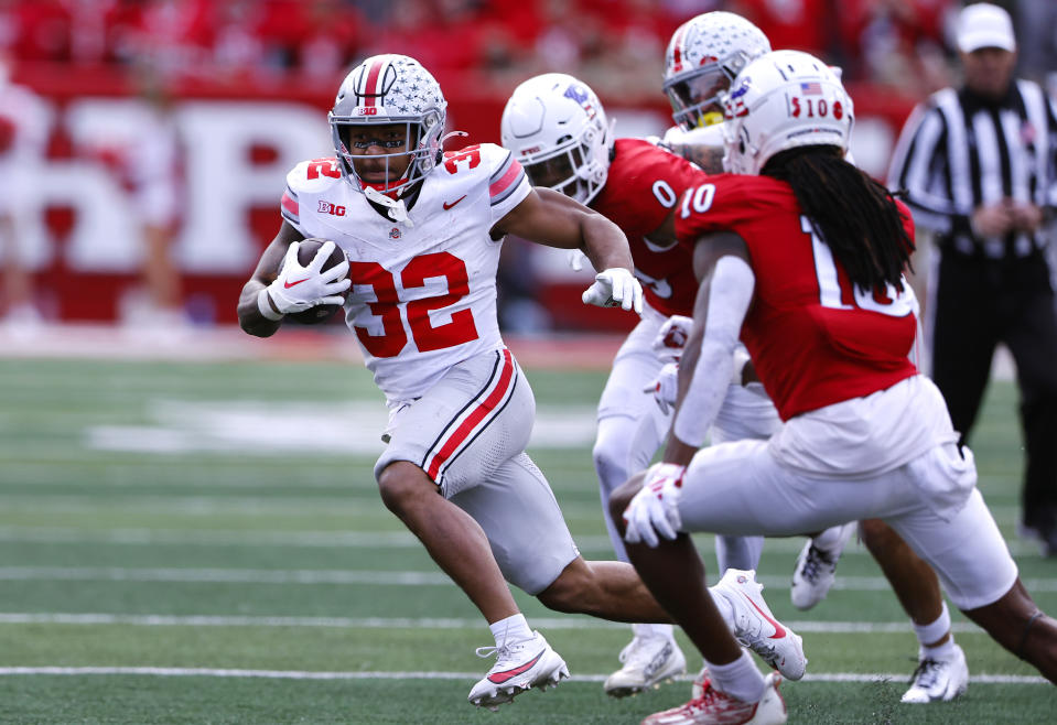 Ohio State running back TreVeyon Henderson (32) rushes against Rutgers defensive back Flip Dixon (10) during the second half of a NCAA college football game, Saturday, Nov. 4, 2023, in Piscataway, N.J. Ohio State won 35-16. (AP Photo/Noah K. Murray)