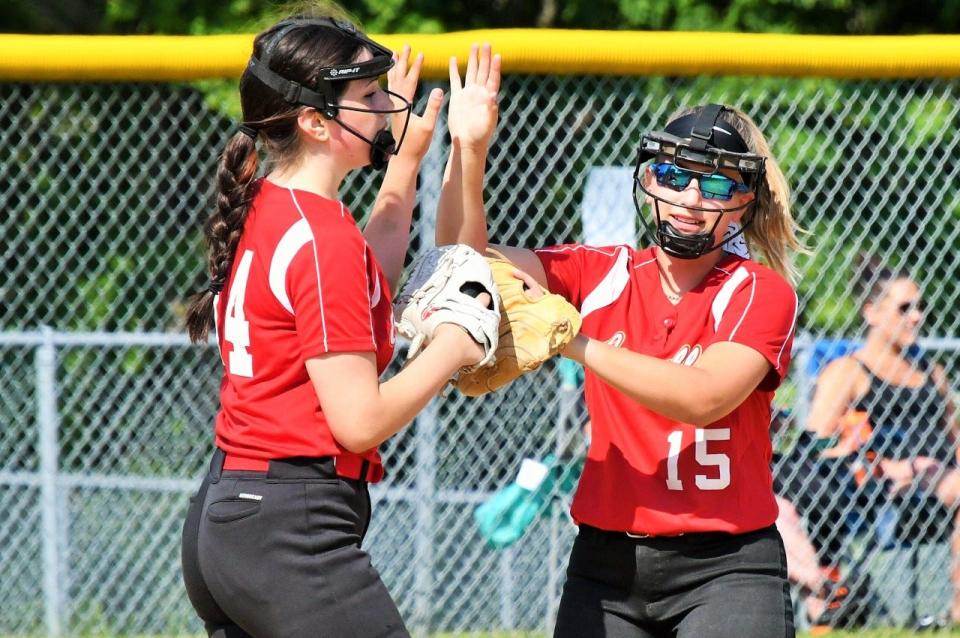 Bishop Connolly's Sam O'Leary, left, gives a teammate a high five after getting the final out of an inning.