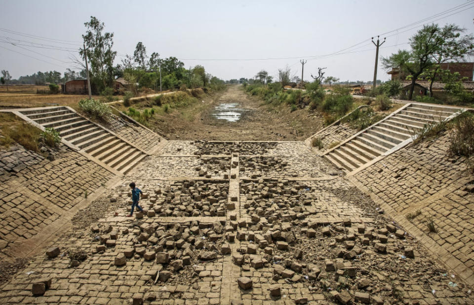 A dried canal on May 21, 2022 in the village of Badokhar, Uttar Pradesh, India, during a severe heatwave which has caused drought conditions in vast swathes of India's agricultural heartlands.<span class="copyright">Ritesh Shukla—Getty Images</span>