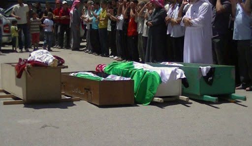 A handout image released by the Syrian opposition's Shaam News Network shows a funeral procession for people who were allegedly killed by pro-regime forces in Daraa. AFP cannot independently verify this image