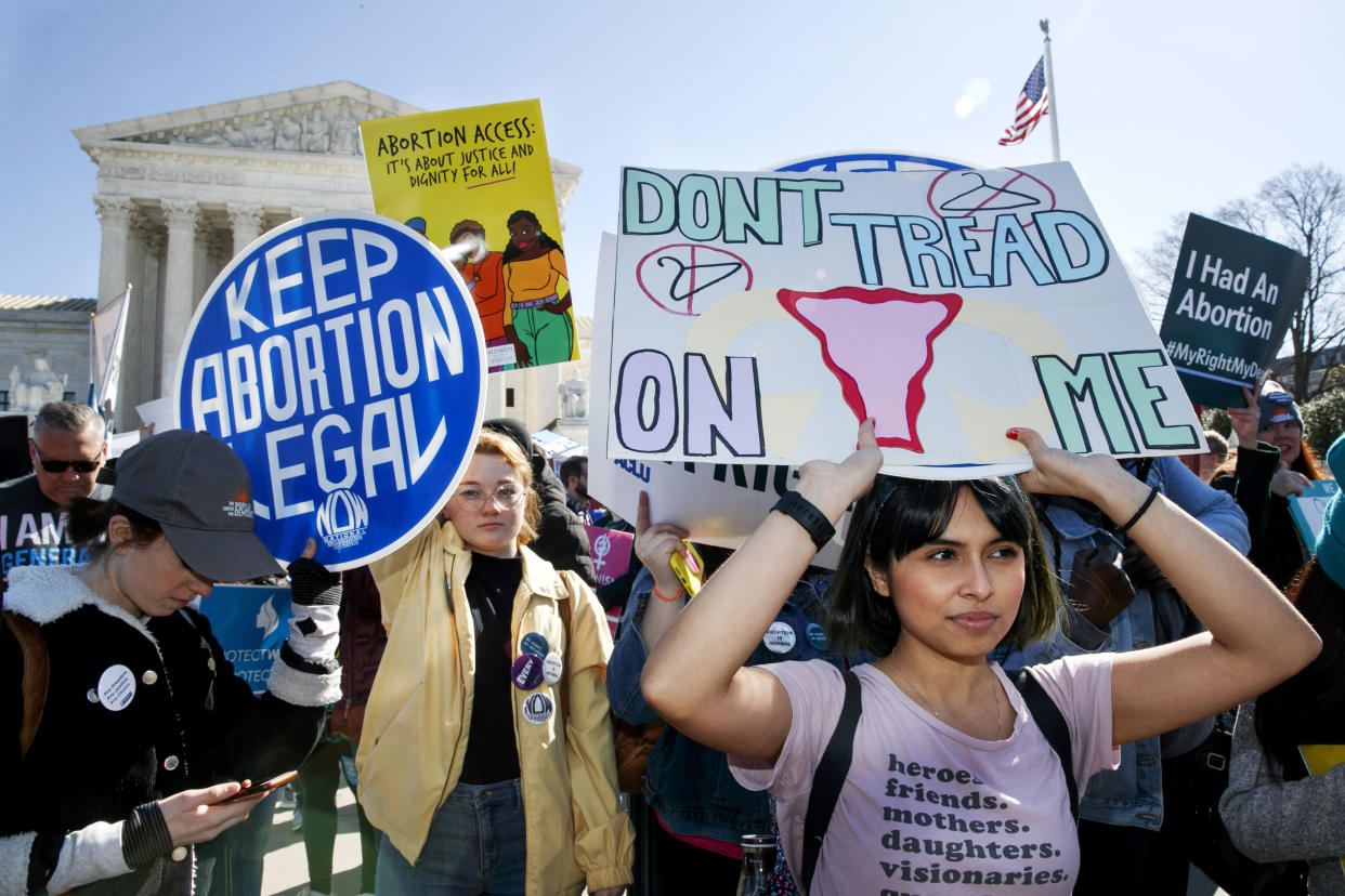 Abortion rights demonstrators rally outside the Supreme Court with signs reading 