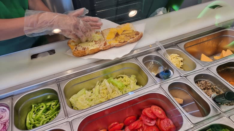 Subway employee making sandwich