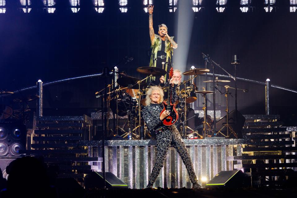 Adam Lambert (top), hits a stratospheric note while drummer Roger Taylor and guitarist Brian May rip through the Queen classic, "Bohemian Rhapsody," at the opening night of their 2023 tour Oct. 4 in Baltimore.