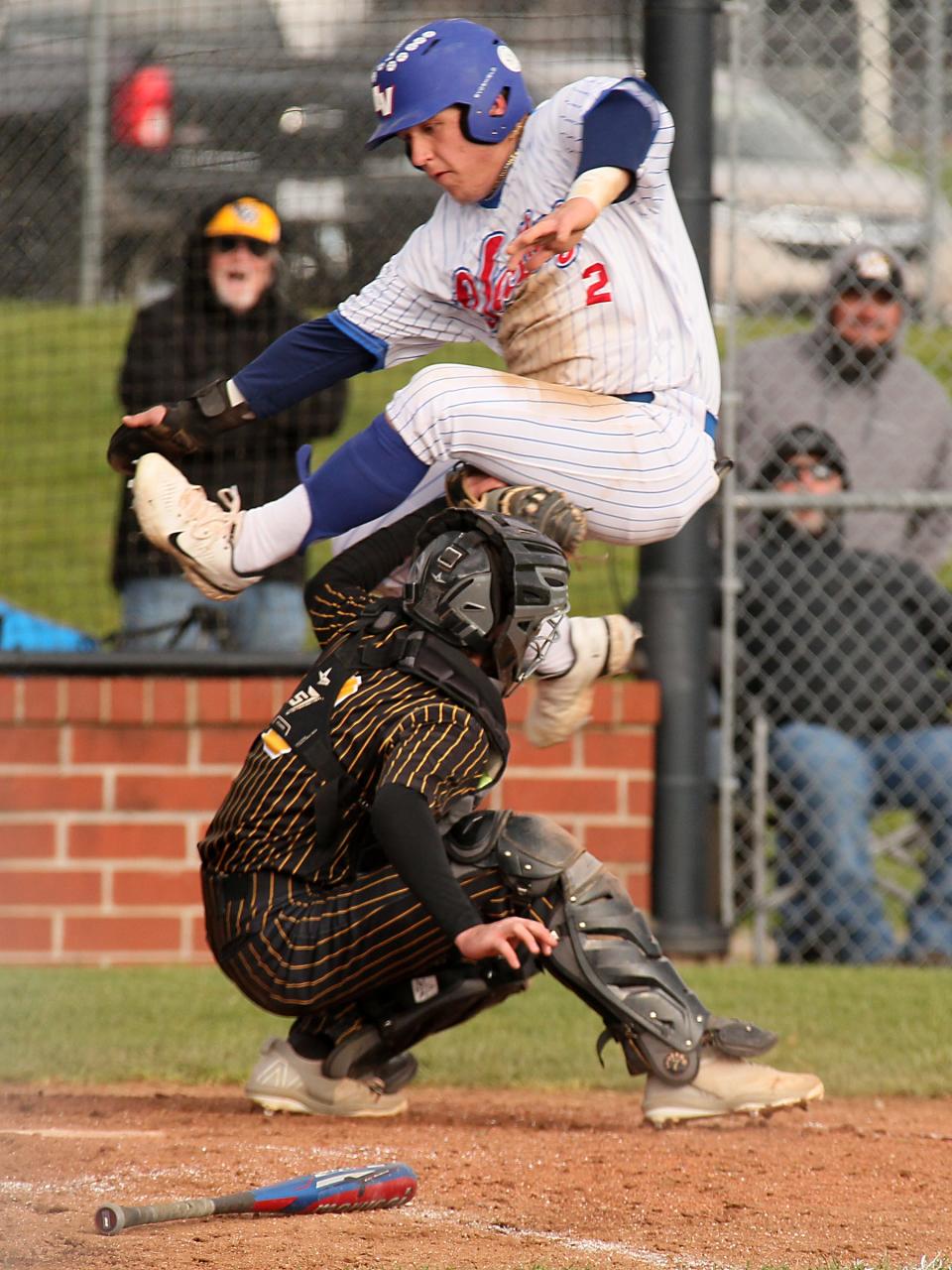 Watkins Memorial's Andrew Botts tags out Licking Valley's Theo Walsh, preventing the tying run from scoring on Monday.