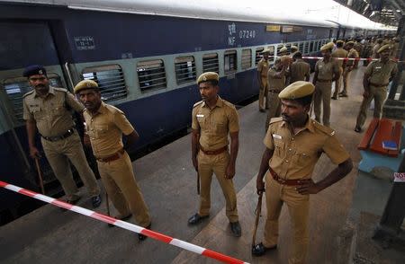 Policemen stand guard next to a passenger train in which two explosions occurred, at the railway station in Chennai May 1, 2014. REUTERS/Babu