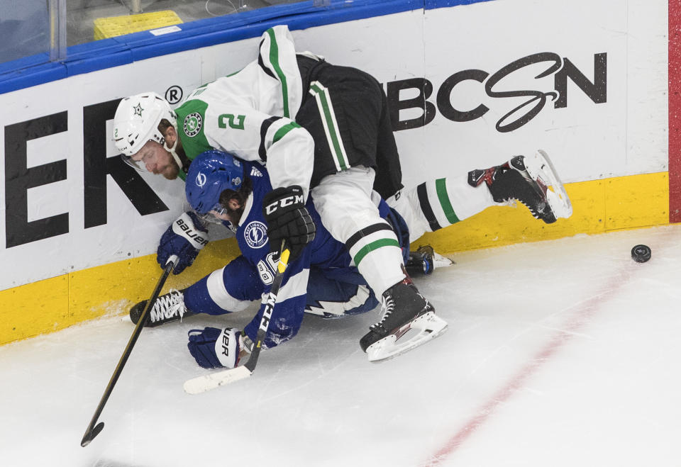 Dallas Stars defenseman Jamie Oleksiak (2) checks Tampa Bay Lightning right wing Nikita Kucherov (86) during third-period NHL Stanley Cup finals hockey action in Edmonton, Alberta, Saturday, Sept. 19, 2020. (Jason Franson/The Canadian Press via AP)