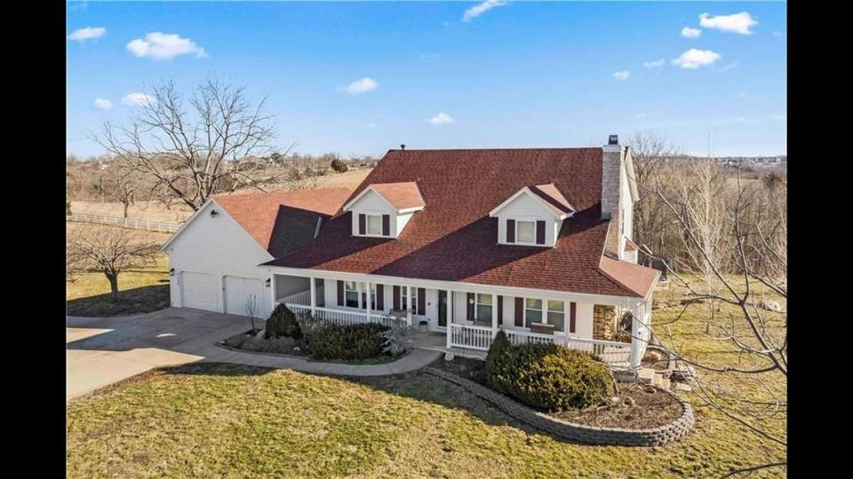 The four-bedroom house at 9100 Cedar Niles Road in Lenexa features a wraparound porch, giving people a look at the backyard, which includes the largest equestrian facility in the area.