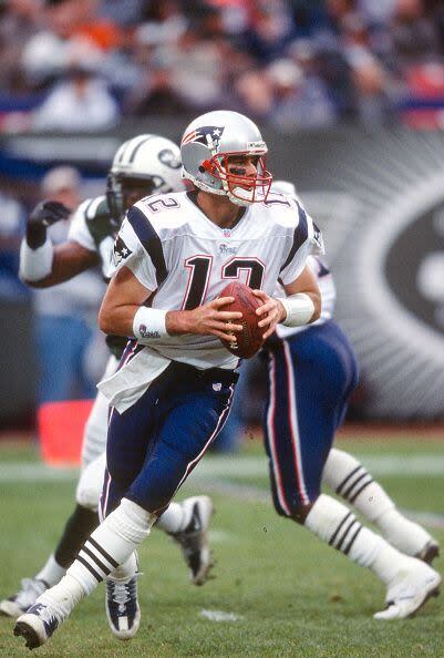 2000: Tom Brady #12 of the New England Patriots drops back to pass against the New York Jets during an NFL football game September 11, 2000 at Giants Stadium in East Rutherford, New Jersey. The Jets won the game 20-19. (Photo by Focus on Sport/Getty Images)