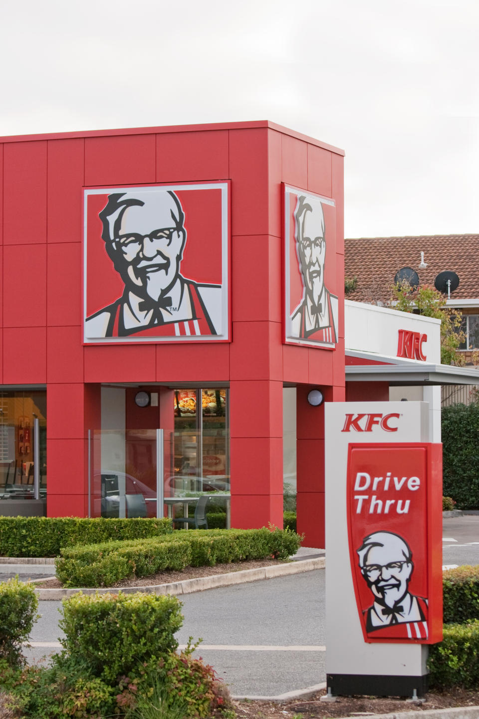  A KFC (Kentucky Fried Chicken) suburban store in Australia. Includes the famous Colonel Sanders trademark and drive through signs. Source: Getty