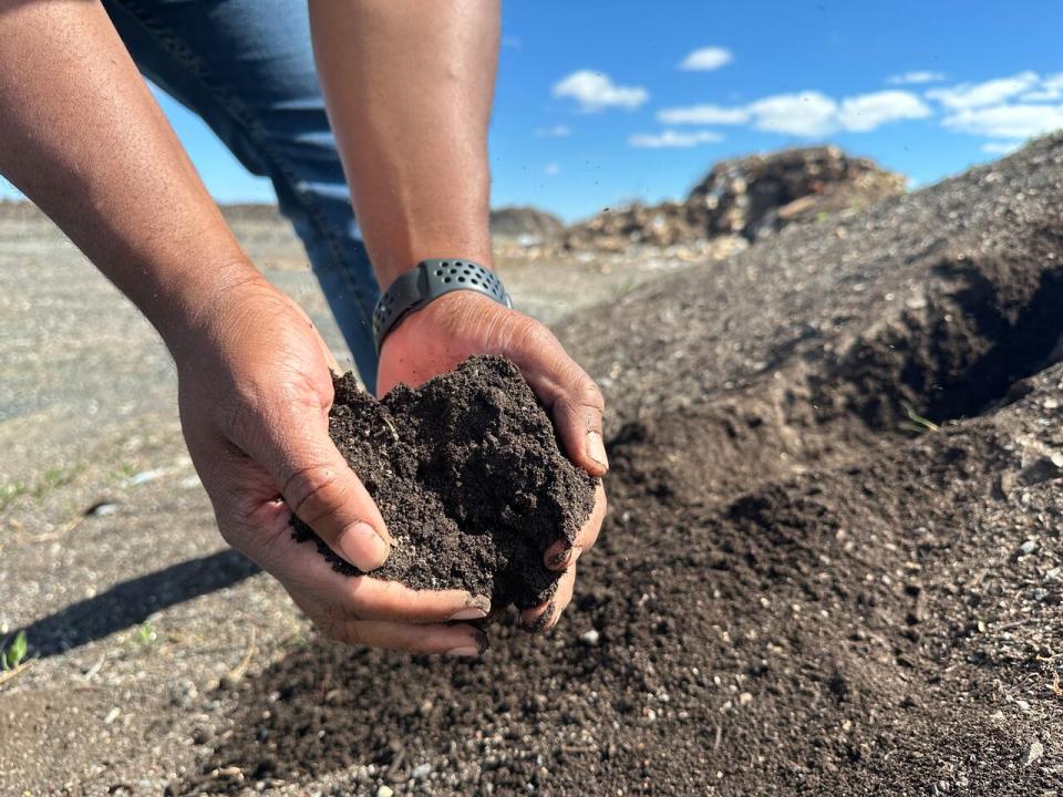 Chris Vaughn, Yellowknife's manager of solid waste and sustainability, holds up a handful of finished compost.