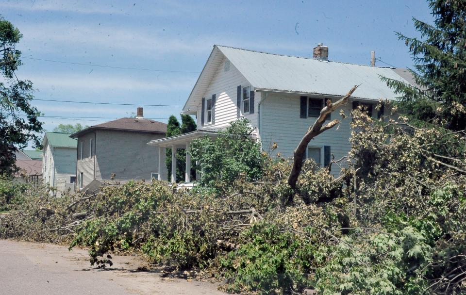 Holmesville residents came together to help each other after Monday night's severe thunderstorm caused much damage and a prolonged power outage.