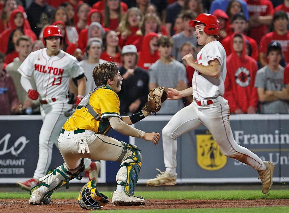 Outfielder Harrison Hinckle scores while on-deck batter Jimmy Fallon has a close up view of the play.
Milton High baseball wins the MIAA State Championship at Polar Park in Worcester on Friday June 16, 2023