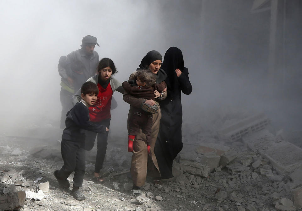 <p>Syrian civilians flee from reported regime air strikes in the rebel-held town of Jisreen, in the besieged Eastern Ghouta region on the outskirts of the capital Damascus, on Feb. 8, 2018. (Photo: Abdulmonam Eassa/AFP/Getty Images) </p>