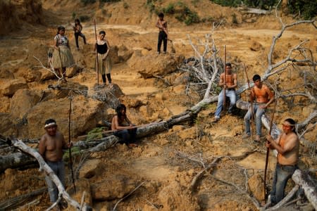 Indigenous people from the Mura tribe show a deforested area in unmarked indigenous lands inside the Amazon rainforest near Humaita