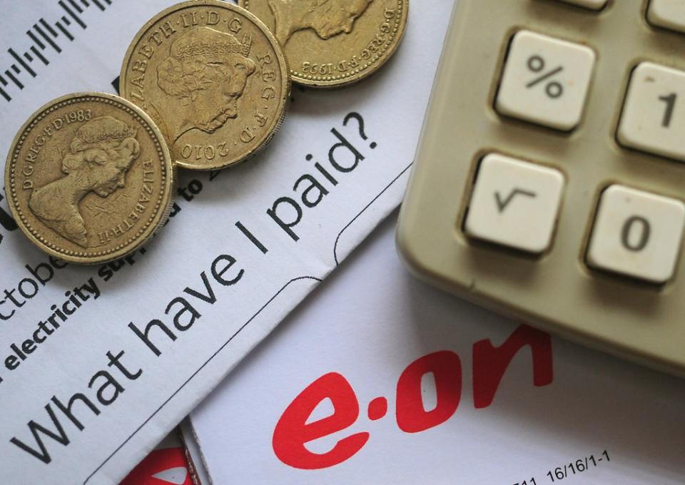 An EON energy bill with pound coins and a calculator.  (PA Archive)