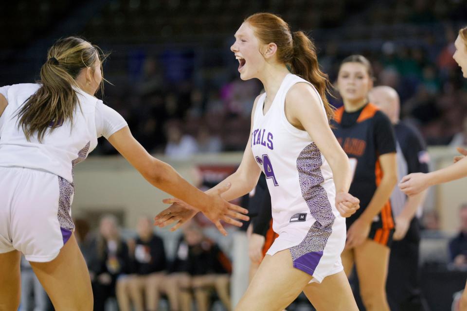Community Christian's Hope Martin, right, celebrates with Preslee Hartsock during a Class 3A girls state basketball game between Community Christian and Roland at State Fair Arena in Oklahoma City, Tuesday, March 5, 2024.