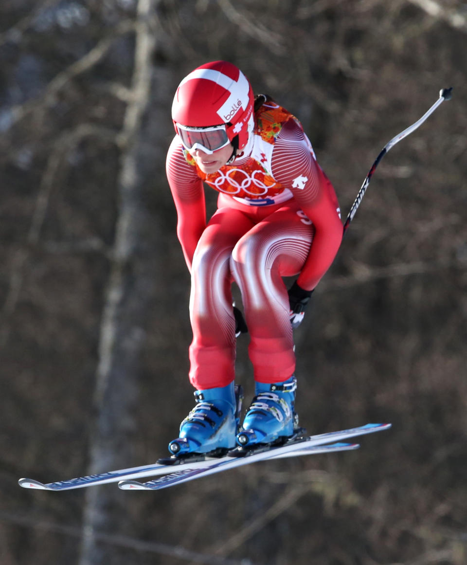 Switzerland's Dominique Gisin makes a jump during a women's downhill training run for the Sochi 2014 Winter Olympics, Saturday, Feb. 8, 2014, in Krasnaya Polyana, Russia. (AP Photo/Luca Bruno)