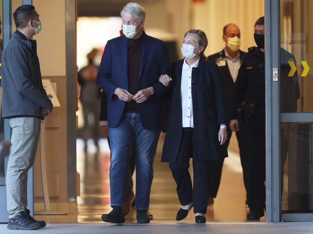 Former President Bill Clinton, standing with his wife, Hillary, was discharged from UC Irvine Medical Center Sunday morning, six days after he was admitted and treated for a urological and blood infection, Orange, California on October 17, 2021.